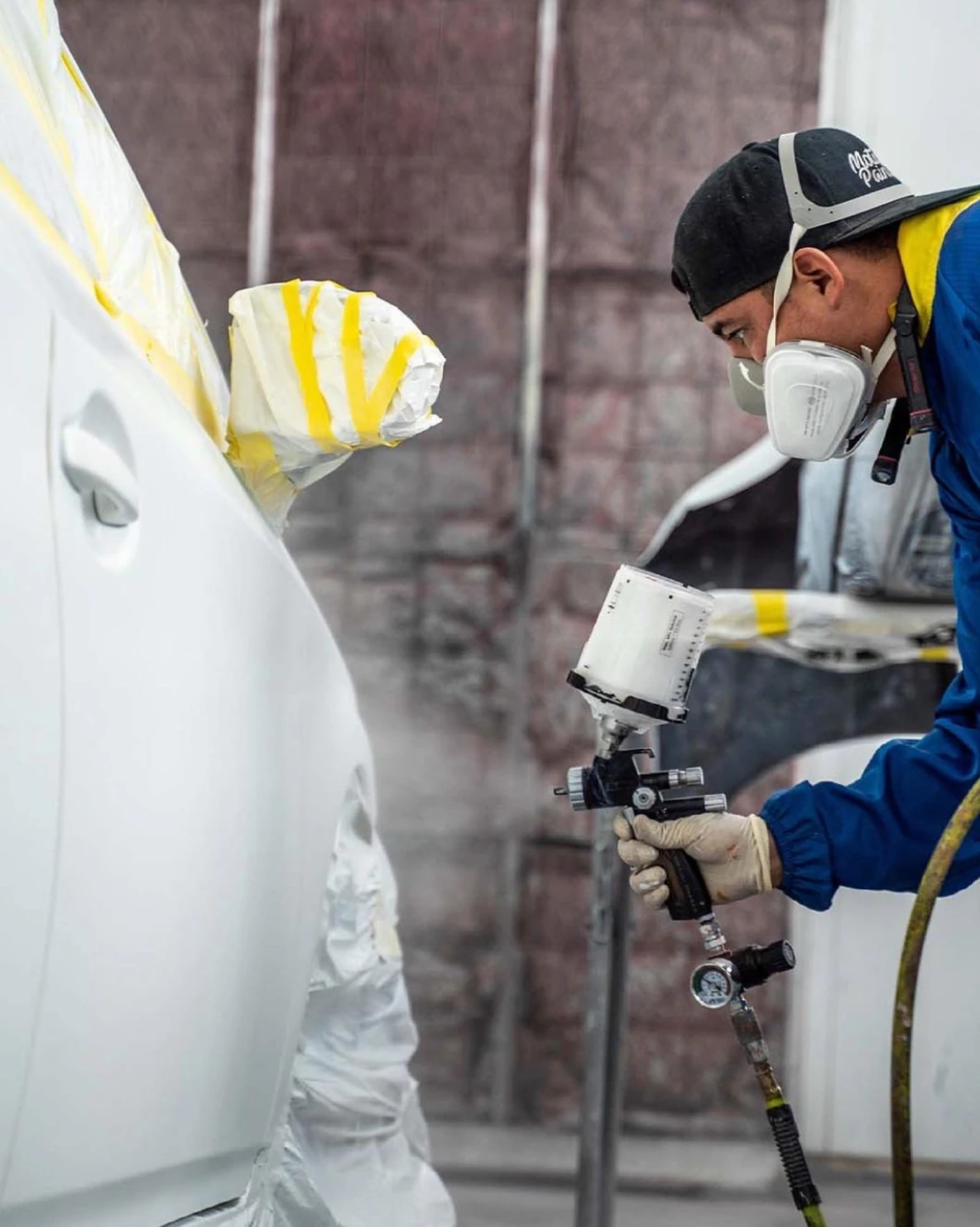 Edward working in the professional paint booth at First Choice Auto Body